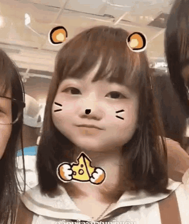a girl with a sticker on her face that looks like a cat