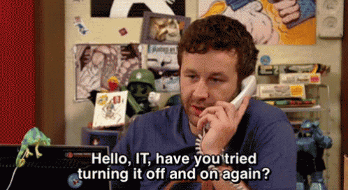 a man is talking on a phone and saying hello it have you tried turning it off and on again