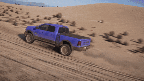 a blue ram truck is driving through the dirt