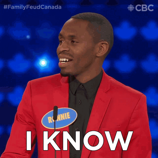 a man in a red suit with a name tag that says ronnie says i know