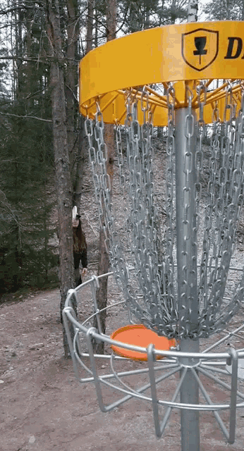 a yellow frisbee golf basket with a cup logo