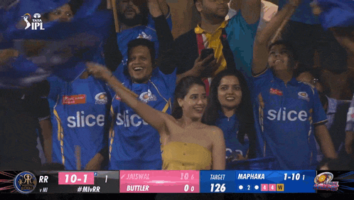a group of people wearing blue slice shirts are watching a cricket game