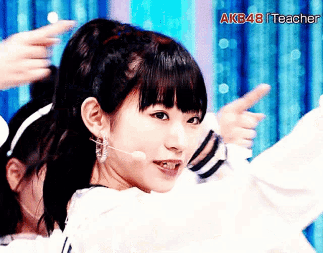 a close up of a woman 's face with the words akb48 teacher on the bottom