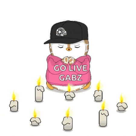 a cartoon penguin wearing a pink hoodie and a black hat surrounded by candles