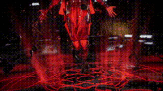 a person in a red costume is standing in a circle of red lights .