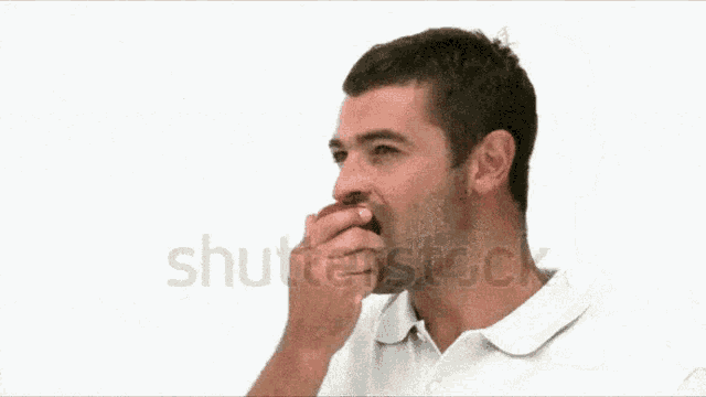 a man in a white shirt is biting an apple