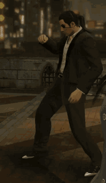 a man in a suit is dancing in front of a building