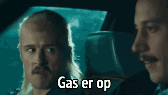 two men in a car with the words gas er op on the bottom right
