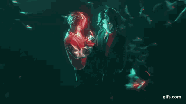 a man and a woman are hugging underwater in a dark room .