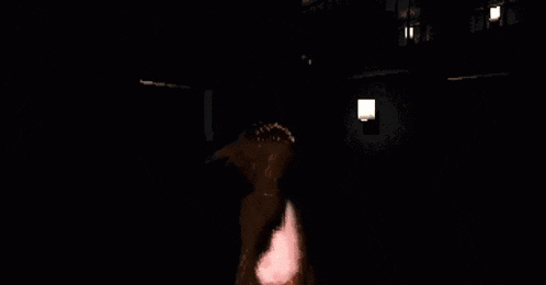 a pixelated image of a burning pumpkin with a red eye