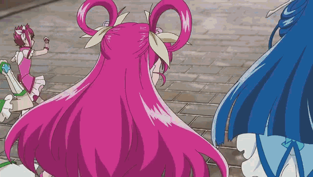 a girl with pink hair is standing next to two other girls