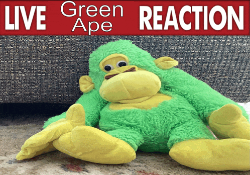 a green stuffed monkey sits under a red sign that says live green ape reaction
