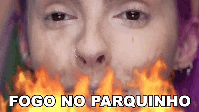 a close up of a woman 's face with flames coming out of her mouth and the words fogo no parquinho below it