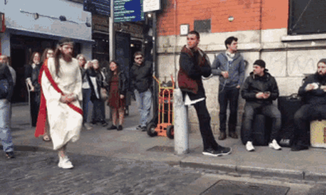 a man in a jesus costume is walking down the street