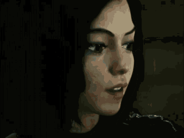 a close up of a woman 's face with a black background