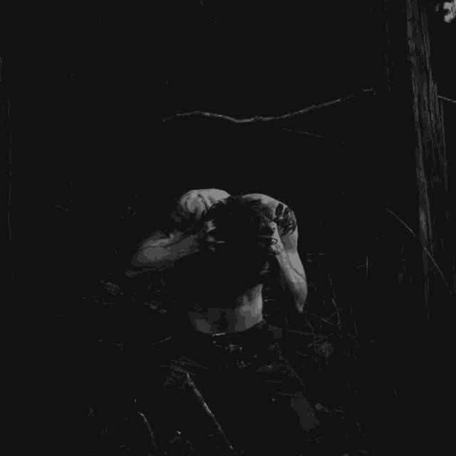 a black and white photo of a man in the dark