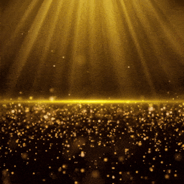 a black background with gold sparkles and rays of light coming down