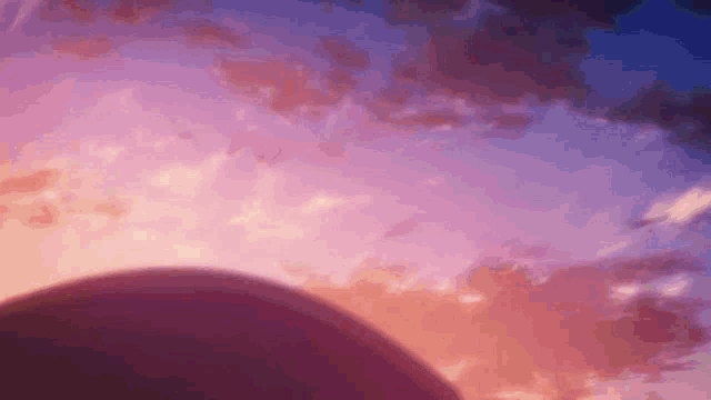a sunset with a purple and pink sky and a circle in the foreground