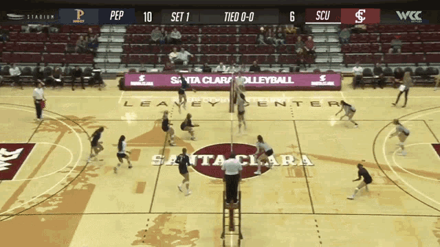 a volleyball game is being played on the santa clara center court