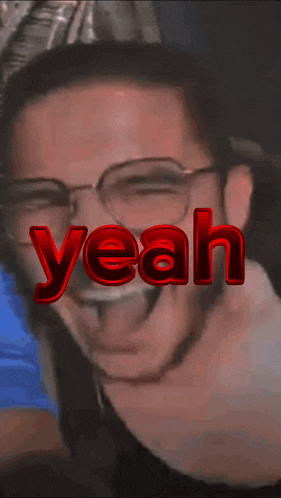 a close up of a man 's face with the word yeah in red letters