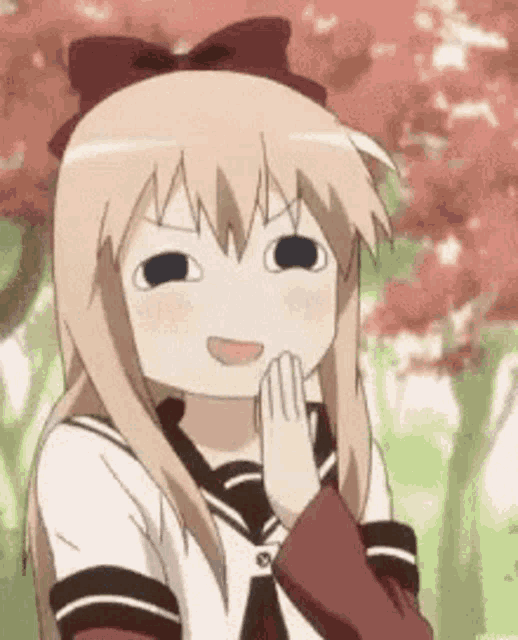 a girl with blonde hair and a bow on her head is making a funny face with her hands on her face .