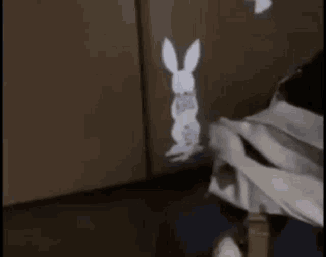 a person is sitting in front of a mirror with a rabbit projected on it .