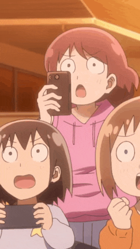 a girl in a pink hoodie is taking a picture of herself