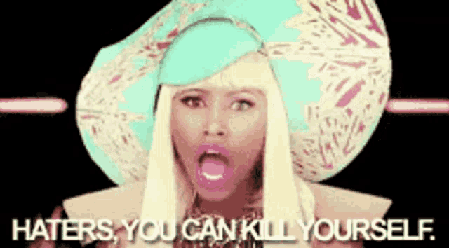 a woman wearing a hat with the words haters you can kill yourself