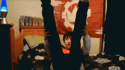 a person laying on their back with their legs up