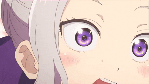 a close up of a girl 's eyes with purple irises