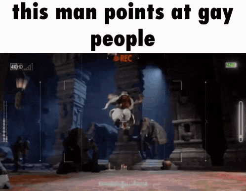 a video of a man jumping in the air with the words this man points at gay people