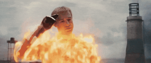 a man with a glove on his head is on fire