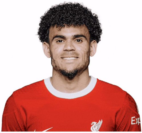 a man with curly hair and a beard wears a red nike shirt