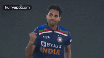 a man in a blue shirt with the word bbyju 's india on it is running .