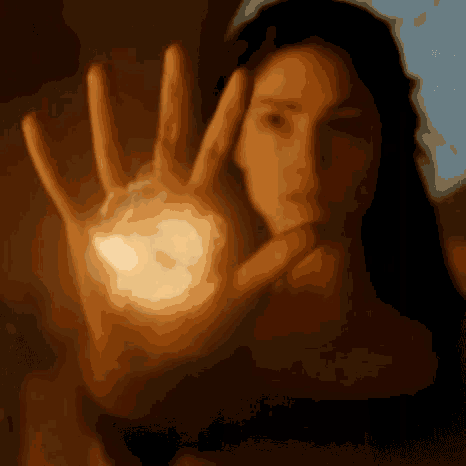 a woman is holding a glowing object in her palm