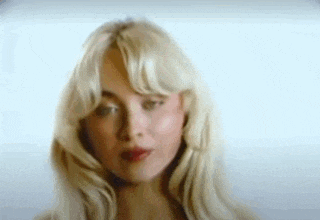 a close up of a woman 's face with blonde hair .