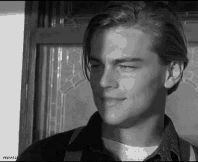 a black and white photo of a young man with his eyes closed .