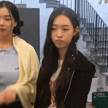 two girls are standing next to each other with one wearing a t-shirt that says ' do ' on it