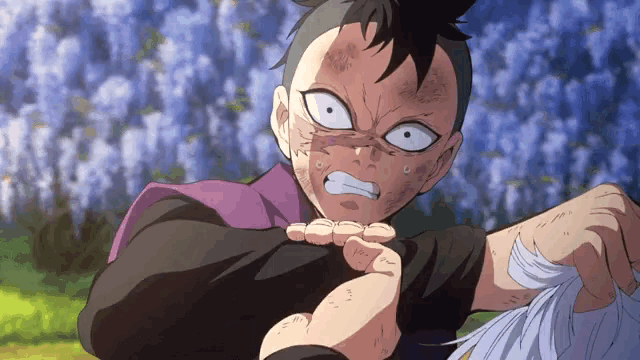 a man with a purple scarf around his neck is holding another man 's hand