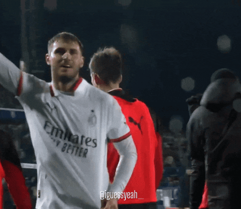 a soccer player wearing a white emirates fly better shirt