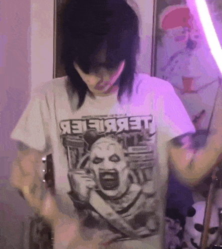 a person wearing a white t-shirt with a picture of a screaming clown and the word jet on it
