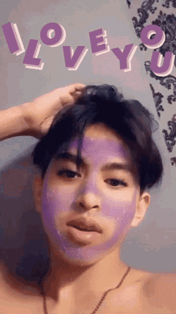 a young man with a purple mask on his face and the words love you behind him
