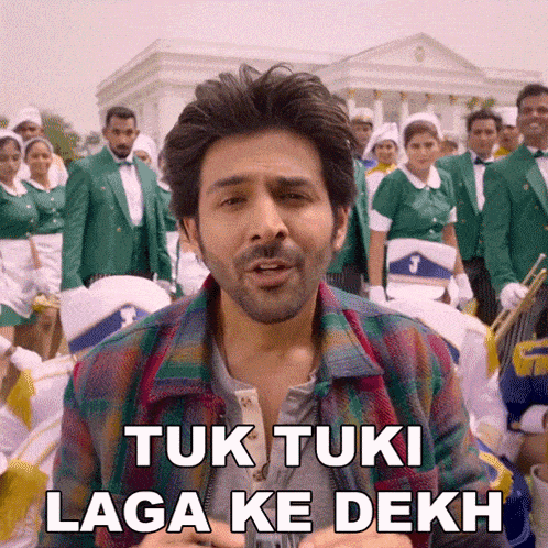 a man is standing in front of a marching band and says " tuk tuki laga ke dekh "