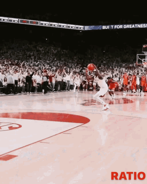 a basketball game is being played in front of a crowd and a sign that says ratio