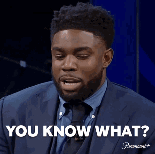 a man in a suit and tie says " you know what " on a screen