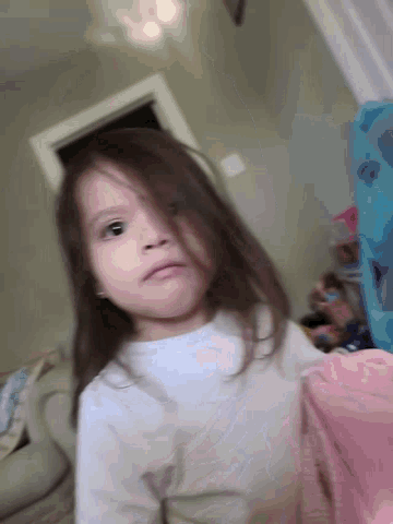 a little girl with a white shirt that says calvin klein on it