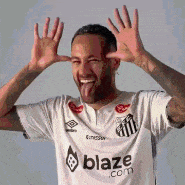 a man wearing a white shirt that says blaze.com sticking his tongue out
