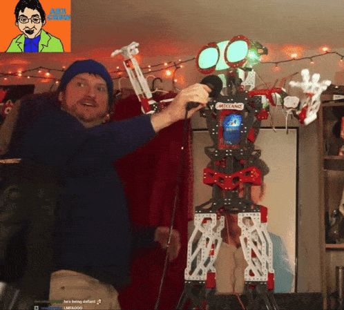 a man is playing with a meccano robot in front of him