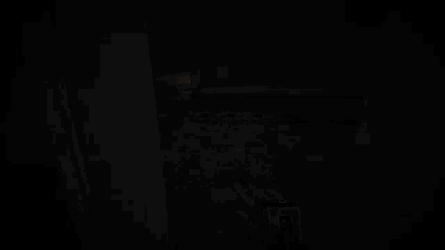 a gun is being fired in a dark room with smoke coming out of the barrel