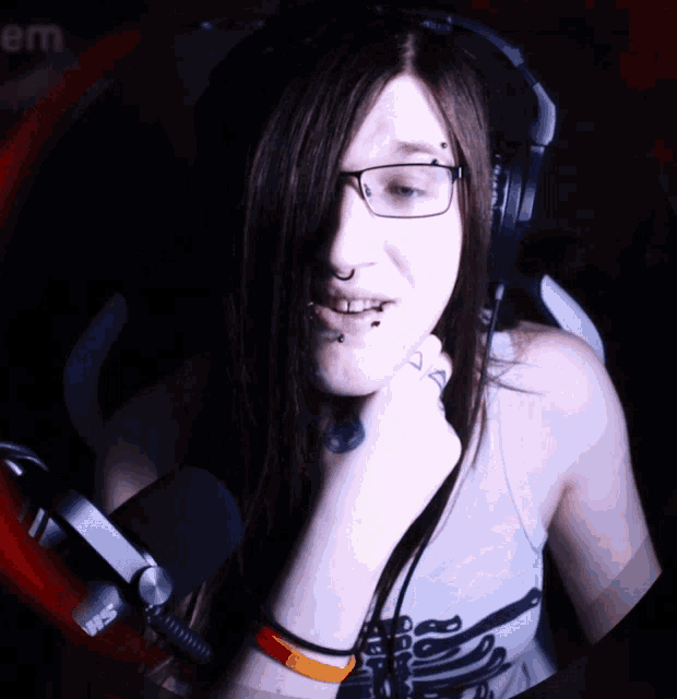 a woman wearing headphones and a shirt that says ' skeleton '